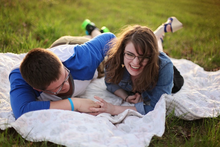 Young couple on a blanket in a field
