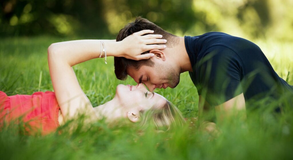 young couple laying in grass