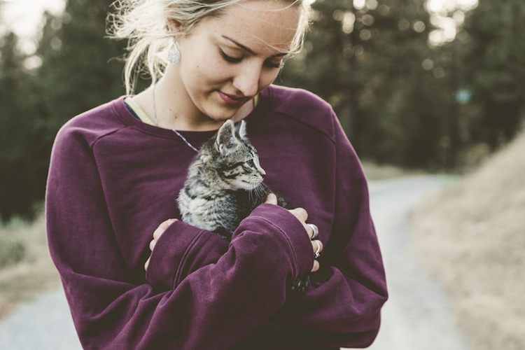 young woman caring for a cat