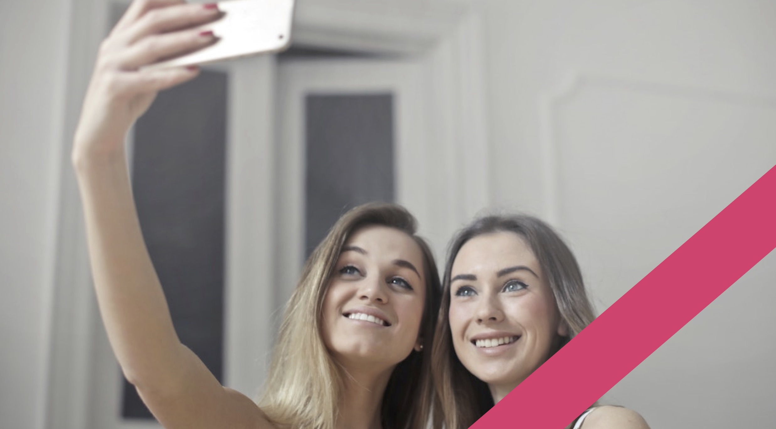 two girls taking a selfie with their phone